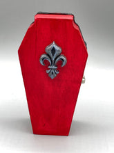 Load image into Gallery viewer, Super vibrant red coffin box has an eye-catching black and gray embellishment in the center, accompanied by a glittery black ribbon around the coffin. Inside, the interior is all black with a floral detailed black-silver cross.