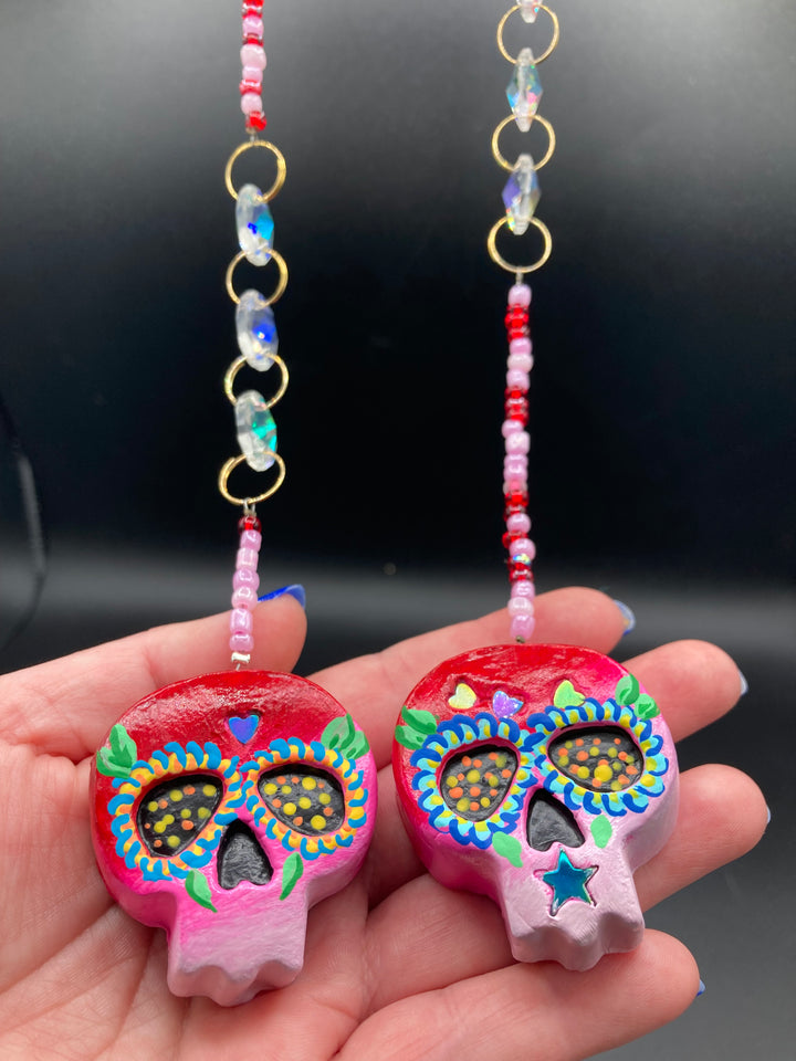 Inspired by nature, these skull statuettes are full of vibrant colors and intricate details that I hand painted. A perfect hanging Day of the Dead art piece to add to your altar, hang next to your display of crystals, add to your skull collection or hang as an art piece on the wall or near a window.