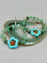 Load image into Gallery viewer, This pair of earrings features a turquoise magnesite floral bead with a vibrant orange glass bead and natural green aventurine stone chips juxtaposed against gold and blue glass beads. Measurements: 2&quot; length 
