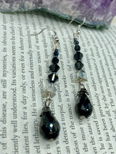 Load image into Gallery viewer, These shimmering black and silver glass beaded earrings feature a large black teardrop glass bead for added movement. This sophisticated and versatile accessory can be worn for an elegant evening look, brunch ensemble, wedding necklace, or minimalist style.  Measurements: 2 1/2” in length
