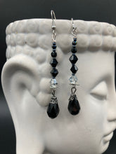 Load image into Gallery viewer, These shimmering black and silver glass beaded earrings feature a large black teardrop glass bead for added movement. This sophisticated and versatile accessory can be worn for an elegant evening look, brunch ensemble, wedding necklace, or minimalist style.  Measurements: 2 1/2” in length
