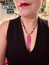 Load image into Gallery viewer, Unlock your inner goddess with this stunning Large Fuchsia Agate Geode Sliced Stone Chip Necklace. Featuring a vibrant fuchsia agate geode pendant surrounded by Rhodonite stone chips and gold and black glass beading, the silver leaf bail completes this chic and boho-inspired look. Make a bold statement with this bohemian-style gemstone necklace. Measurements: Necklace is 17 3/4” in length - pendant is 3” Height
