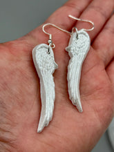 Load image into Gallery viewer, Shimmery white polymer clay earrings in the shape of angel wings are perfect for a subtle yet elegant look.
