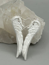 Load image into Gallery viewer,  Shimmery white polymer clay earrings in the shape of angel wings are perfect for a subtle yet elegant look.
