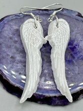 Load image into Gallery viewer, Shimmery white polymer clay earrings in the shape of angel wings are perfect for a subtle yet elegant look.
