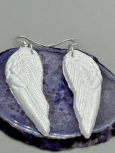Load image into Gallery viewer, Shimmery white polymer clay earrings in the shape of angel wings are perfect for a subtle yet elegant look.
