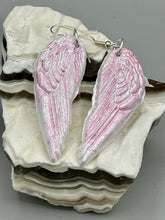 Load image into Gallery viewer, Light pastel pink polymer clay earrings in the shape of angel wings are perfect for a subtle yet elegant look. These earrings are designed to face forward when worn for a more flattering silhouette.
