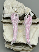 Load image into Gallery viewer, Light pastel pink polymer clay earrings in the shape of angel wings are perfect for a subtle yet elegant look. These earrings are designed to face forward when worn for a more flattering silhouette.
