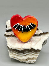 Load image into Gallery viewer, This hand-crafted art magnet is featuring a black bat with an ombre background of yellow, orange and bright red. This art clay magnet is the ideal home decor for Halloween enthusiasts. Perfect for adorning a witchy altar, goth, or spooky Halloween home decor.  Halloween magnet art to add to your fridge, locker, cubicle or toolbox. This hand-crafted heart-shaped magnet features a black bat figurine with ombre colors of yellow, orange and bright red.
