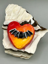 Load image into Gallery viewer, This hand-crafted art magnet is featuring a black bat with an ombre background of yellow, orange and bright red. This art clay magnet is the ideal home decor for Halloween enthusiasts. Perfect for adorning a witchy altar, goth, or spooky Halloween home decor.  Halloween magnet art to add to your fridge, locker, cubicle or toolbox. This hand-crafted heart-shaped magnet features a black bat figurine with ombre colors of yellow, orange and bright red.
