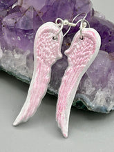 Load image into Gallery viewer, Light pastel pink polymer clay earrings in the shape of angel wings are perfect for a subtle yet elegant look. These earrings are designed to face forward when worn for a more flattering silhouette.
