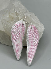 Load image into Gallery viewer, Light pastel pink polymer clay earrings in the shape of angel wings are perfect for a subtle yet elegant look. These earrings are designed to face forward when worn for a more flattering silhouette.
