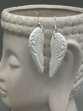 Load image into Gallery viewer, Shimmery white polymer clay earrings in the shape of angel wings are perfect for a subtle yet elegant look.
