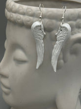 Load image into Gallery viewer, Shimmery white polymer clay earrings in the shape of angel wings are perfect for a subtle yet elegant look.
