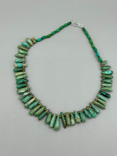 Load image into Gallery viewer, This striking Extra Large Turquoise Stone Beaded Necklace With Brass Finish Metal Beads instantly adds a touch of luxury to any outfit. Beautifully crafted with an alluring blend of extra large turquoise stone beads and brass finish metal beads, this distinctive necklace invokes an elegant cascade of vibrant color.    Measurements:    Necklace is 21 1/2 &quot; in length adjustable to 23&quot;
