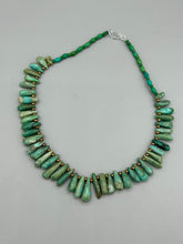 Load image into Gallery viewer, This striking Extra Large Turquoise Stone Beaded Necklace With Brass Finish Metal Beads instantly adds a touch of luxury to any outfit. Beautifully crafted with an alluring blend of extra large turquoise stone beads and brass finish metal beads, this distinctive necklace invokes an elegant cascade of vibrant color.    Measurements:    Necklace is 21 1/2 &quot; in length adjustable to 23&quot;
