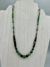 Load image into Gallery viewer, This exquisite necklace features natural ruby zoisite, black obsidian, turquoise magnesite, bone, glass and metal beads, offering a variety of sizes, shapes, textures, and colors.    Measurements:  Necklace - 20&quot; in length
