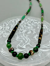 Load image into Gallery viewer, This exquisite necklace features natural ruby zoisite, black obsidian, turquoise magnesite, bone, glass and metal beads, offering a variety of sizes, shapes, textures, and colors.    Measurements:  Necklace - 20&quot; in length
