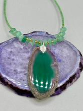 Load image into Gallery viewer, This Dark Green Agate Geode Sliced Stone Chip Necklace is a statement piece for your jewelry collection. It features a bold dark green agate geode pendant surrounded by a green aventurine, gold tone and green glass beaded necklace. The silver leaf bail completes this chic, Boho-inspired necklace.  Measurements:   Necklace is 19” in length - pendant is 2 1/4” Height

