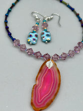 Load image into Gallery viewer, This bold and vibrant piece of jewelry features blue, purple, and gold glass beads of different sizes and shapes that are artfully combined to create a unique texture. An essential addition to any jewelry collection. Measurements: 1 ” in length
