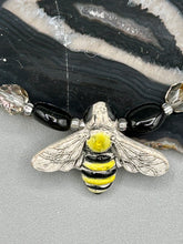 Load image into Gallery viewer, This beautiful Bee Pendant With Black and Yellow Beaded Necklace is the perfect accessory for any summer outfit. The vibrant colors will make a bold statement, while the black and gold blend adds a subtle elegance. Its perfect for any nature lover, hippie, or witchy style.  Measurements:  Necklace is 18”

