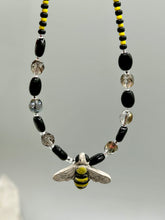 Load image into Gallery viewer, This beautiful Bee Pendant With Black and Yellow Beaded Necklace is the perfect accessory for any summer outfit. The vibrant colors will make a bold statement, while the black and gold blend adds a subtle elegance. Its perfect for any nature lover, hippie, or witchy style.  Measurements:  Necklace is 18”
