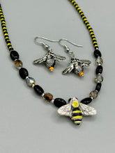 Load image into Gallery viewer, Honey bee shaped metal fish hook earrings with black and yellow glass beads. Measurement: 1&quot; in length
