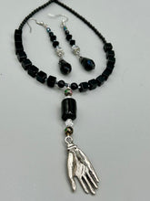 Load image into Gallery viewer, These shimmering black and silver glass beaded earrings feature a large black teardrop glass bead for added movement. This sophisticated and versatile accessory can be worn for an elegant evening look, brunch ensemble, wedding necklace, or minimalist style.  Measurements: 2 1/2” in length
