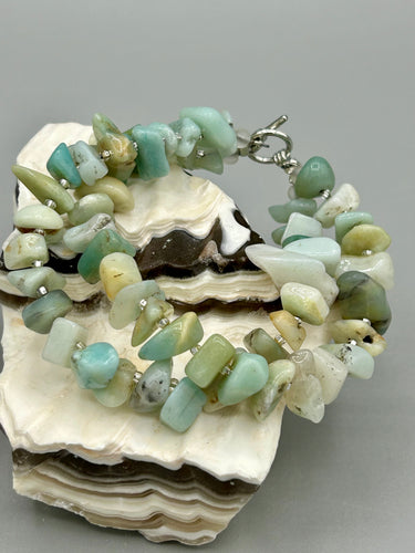 Nature inspired double-strand genuine amazonite chip stone beaded bracelet. Crafted with metal wire and fastened with a toggle clasp.  Measurements: 7 3/4