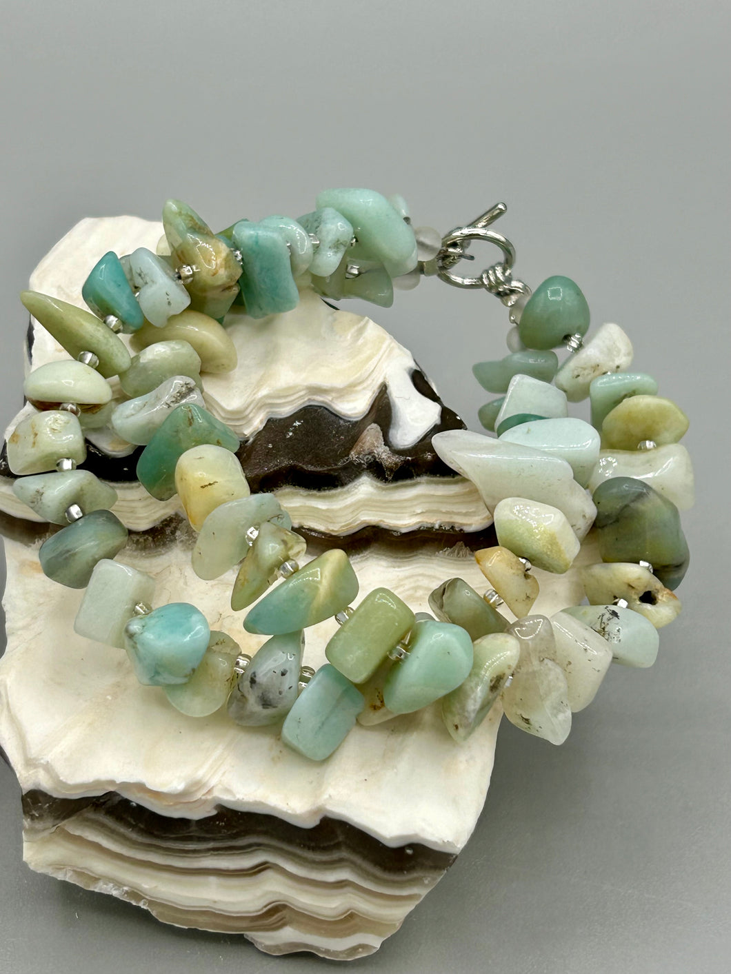 Nature inspired double-strand genuine amazonite chip stone beaded bracelet. Crafted with metal wire and fastened with a toggle clasp.  Measurements: 7 3/4