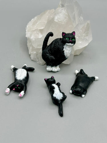 Cat lovers dream, this hand-crafted black tuxedo cat magnet art is the purrfect decoration on refrigerators, lockers, cubicles or toolboxes. The set includes three mini cat figurines, featuring emerald green eyes.