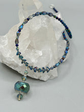 Load image into Gallery viewer, Make a bold statement with this shimmery aqua blue and blue tones glass beaded necklace. The round faceted shaped pendant compliments the cool tones of the necklace, perfect for adding a rich pop of color to any Spring outfit. The draped design gives this piece an elegant, bohemian look.  Measurements:    Necklace is 18” in length, pendant is 1 1/2”
