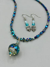 Load image into Gallery viewer, Beautiful delicate glass beaded earrings featuring silver-plated night owl charms in an enchanting pale blue hue.  Measurements: 1 1/4” in length
