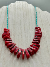Load image into Gallery viewer, Experience the striking beauty of Southwest Style with this necklace adorned with vibrant blue turquoise and bold red coral beads. Complete the look with matching earrings, perfect for any occasion. Skillfully crafted using metal wire and secured with a hook-eye clasp for a secure and stylish finish.

Measurements: 21" in length
