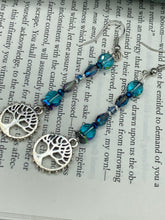 Load image into Gallery viewer, This captivating set of earrings boasts an exquisite range of intense blues and purples, accented with a warm touch of gold and green. The dangling silver plated tree of life charm adds a beautiful finishing touch.  Measurements: 2 1/2” in length
