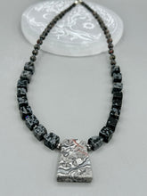 Load image into Gallery viewer, This rustic necklace features an eye-catching large trapezoid-shaped Picasso jasper, hematite, square-shaped snowflake obsidian combo set in a unique and chic design. Handcrafted from genuine stones, this necklace is perfect for any bohemian look.   Measurements:  Necklace is 21&quot;
