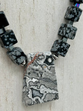 Load image into Gallery viewer, This rustic necklace features an eye-catching large trapezoid-shaped Picasso jasper, hematite, square-shaped snowflake obsidian combo set in a unique and chic design. Handcrafted from genuine stones, this necklace is perfect for any bohemian look.   Measurements:  Necklace is 21&quot;
