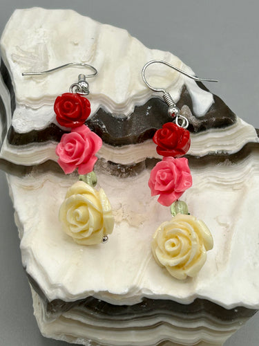 Crafted from quartzite, these highly detailed rose beads come in three striking shades of red, soft pink, and white beaded earrings. This is the ideal accessory for those interested in Dia De Los Muertos as well as those with an appreciation for gardens. Whether dressing up or down, these earrings will lend a distinctive touch to your fashion.  Measurements: 1 1/2” in length 