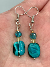 Load image into Gallery viewer, The Whimsical Teal Blue-Purple Glass Beaded Earrings feature a delightful mix of blues, purples, and hints of gold, along with varied sizes and shapes for an eye-catching textural look. The quartzite beads have a captivating swirl pattern, combining dark red and dark blue hues.  Measurements: 1 1/2 ” in length
