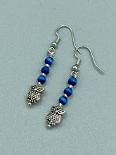 Load image into Gallery viewer, Chic and fun silver-plated owl charm earrings featuring delicate dark blue cats eye beads. Measurements: 1 3/16” in length
