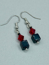 Load image into Gallery viewer, This eye-catching piece features two unconventional components: a large square-shaped black obsidian bead and a large, dark red glass bead. With the beautiful interplay of colors and shapes, these earrings are truly unique, yet at the same time, versatile enough to be paired with a range of styles.  Measurements: 1” in length 
