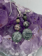 Load image into Gallery viewer, These earrings are crafted with turmaline quartz, snowflake obsidian and black glass beads, creating a neutral cool look that is both unique and adaptable to any style.  Measurements: 1 1/2” in length
