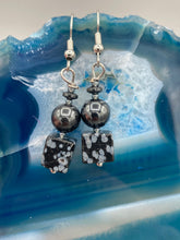 Load image into Gallery viewer, These earrings feature large square shape snowflake obsidian beads complemented with round hematite beads. The neutral cool tones of the stone beads create a unique and versatile style. Measurements: 1 1/4” in length
