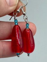 Load image into Gallery viewer, This eye-catching piece set of earrings consists of large fire engine red and tiny teal glass beads for a vibrant and bold look.  Measurements: 1 1/2” in length 
