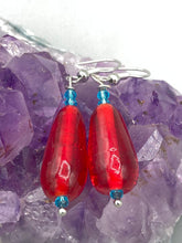 Load image into Gallery viewer, This eye-catching piece set of earrings consists of large fire engine red and tiny teal glass beads for a vibrant and bold look.  Measurements: 1 1/2” in length 
