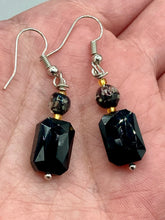 Load image into Gallery viewer, Elegantly crafted from black rectangular and circular glass beads, these dainty earrings offer a versatile style that can effortlessly elevate any ensemble.  Measurements: 1 3/8” in length
