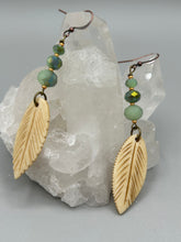 Load image into Gallery viewer, Single-stranded earring features bone carved leaf charm earrings with light mint faceted round glass beads.  Glass beads have a tint of dark green and gold shimmer. Antique Copper Plated Surgical Steel Hammered Long Ear-wire French Hook Earrings.  Measurements: 3” in length  
