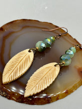 Load image into Gallery viewer, Single-stranded earring features bone carved leaf charm earrings with light mint faceted round glass beads.  Glass beads have a tint of dark green and gold shimmer. Antique Copper Plated Surgical Steel Hammered Long Ear-wire French Hook Earrings.  Measurements: 3” in length  
