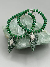 Load image into Gallery viewer, Green-White Qinghai Green Jasper Stone Beaded Hoop Earrings provide a nature-inspired look that is perfect for any boho-chic style. These earrings feature natural green jasper stone triangle pendant with small beads of silver and dark apple green magnesite stone for subtle accent. Show off your bohemian look with these eye-catching hoops.  Measurements: 3&quot; length 
