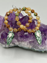 Load image into Gallery viewer, Green-White Qinghai Green Jasper Stone Beaded Hoop Earrings provide a nature-inspired look that is perfect for any boho-chic style. These earrings feature natural green jasper stone triangle pendant with champagne mix melon Czech faceted round glass beads.  Glass beads have a tint of light champagne, amber, dark green and gold shimmer for subtle accent. Show off your bohemian look with these eye-catching hoops. Antique Copper Plated Surgical Steel Hammered Long Ear-wire French Hook Earrings. 
